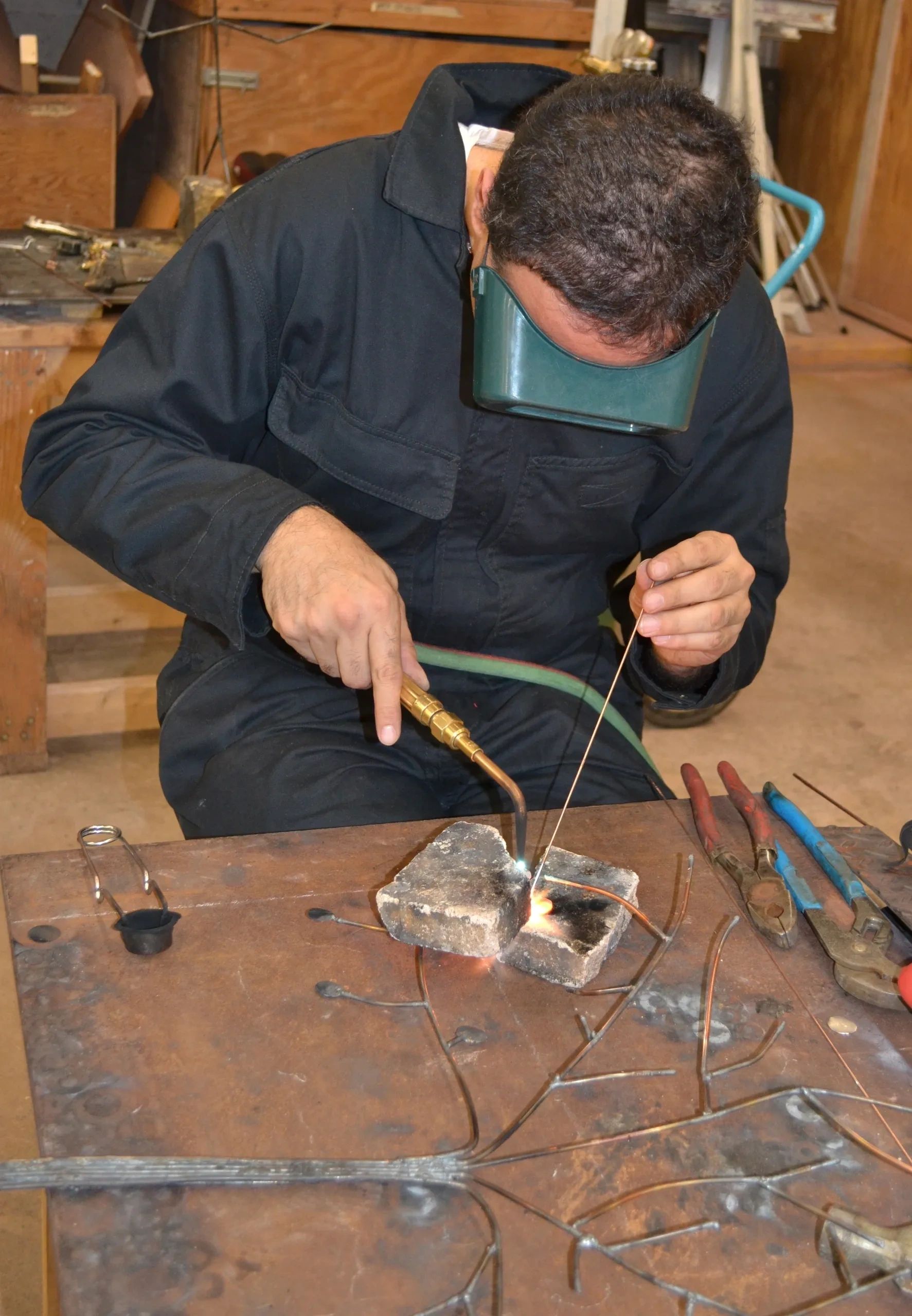 Students learning metalworking and stone carving at Brian Kirk Studios